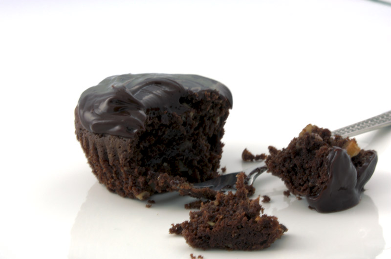 Deep chocolate Brownie Cupcake A close up photo of a chocolate brownie cupcake and a silver fork.