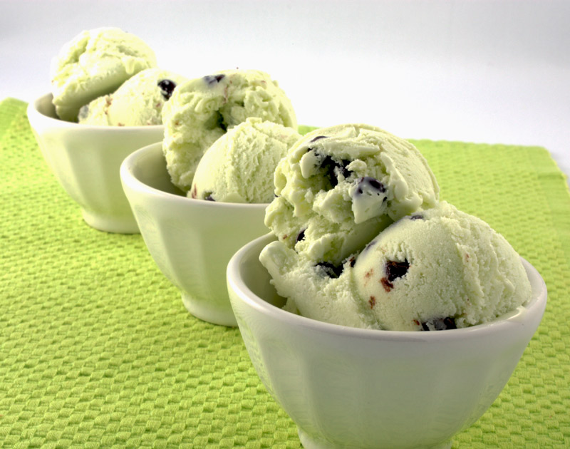 Mint Chocolate Chip Ice Cream A photo of 3 white bowls of mint chocolate chip ice cream on a green placemat.