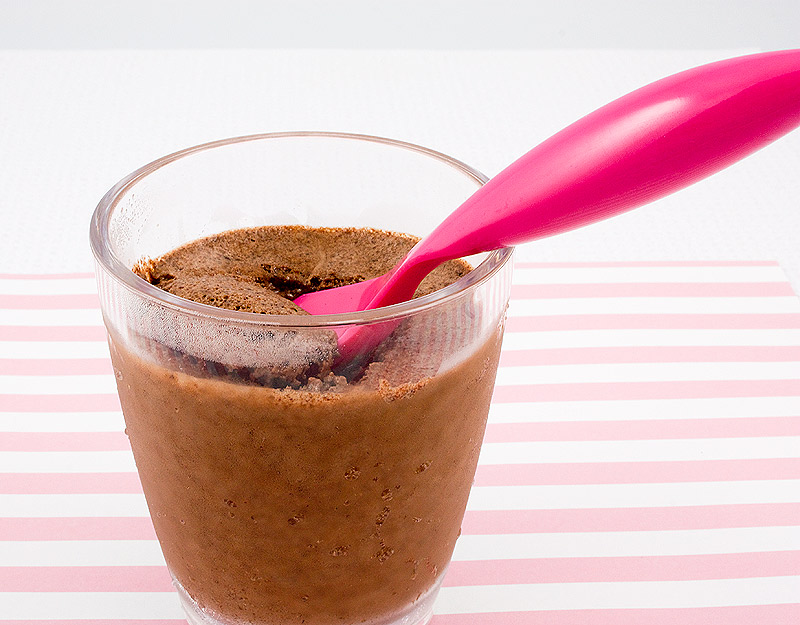 double chocolate brownie semifreddo, Donna Hay's double chocolate brownie semifreddo recipe, Donna Hay's semifreddo recipes A close up photo of a double chocolate brownie semifreddo dessert with a pink spoon sitting on cup placed on a pink candy striped piece of paper.
