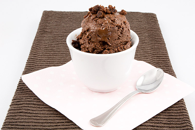 double chocolate brownie semifreddo, Donna Hay's double chocolate brownie semifreddo recipe, Donna Hay's semifreddo recipes A photo of a double chocolate brownie semifreddo dessert garnished with brownie bits, sitting atop a pink polka dotted napkin with a spoon on a brown tea towel.