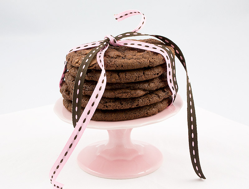 Double-Chocolate Chunk Cookies, recipe for double chocolate chunk cookies, easy double chocolate chunk cookies, Martha Stewart's recipe for double chocolate cookies A photo of a stack of 5 double-chocolate chunk cookies tied with 2 ribbons, one pink and 1 brown, placed on a mini, pink cupcake stand.