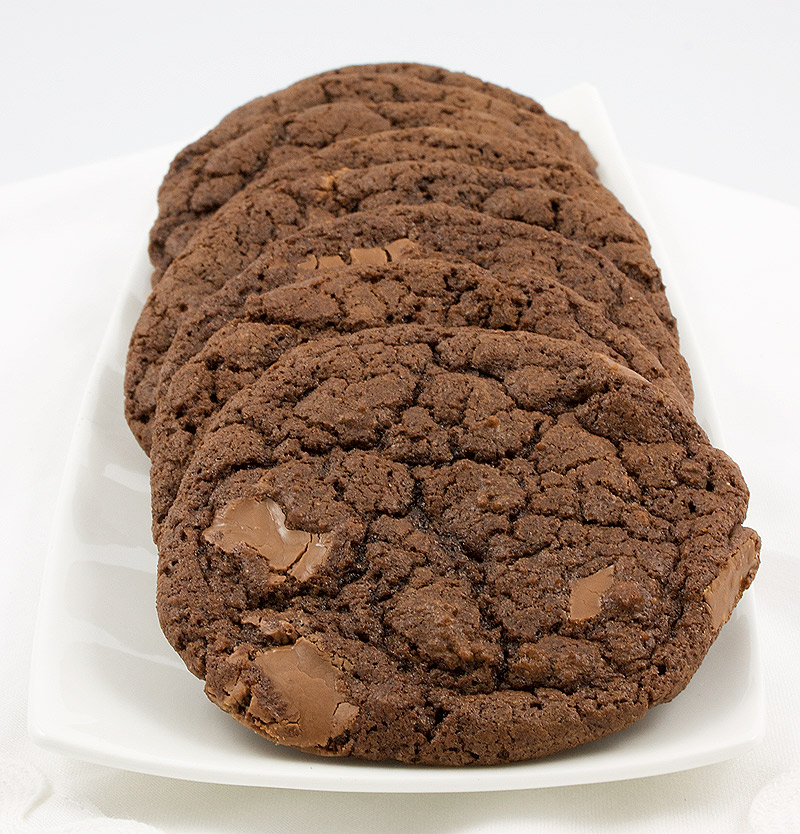 double-chocolate chunk cookies, Martha Stewart double-chocolate cookie recipe, easy chocolate chunk cookie recipe, recipe for double-chocolate chunk cookies A photo of double-chocolate chunk cookies on a white dish placed on a white napkin.