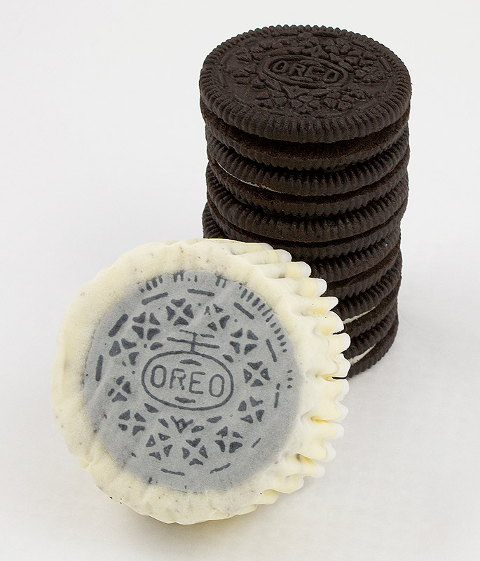 Oreo cookies and cream cheesecake cupcakes, Martha Stewart's cupcake recipes, cookies and cream cheesecakes recipe A photo of an Oreo cookies and cream cheesecake with the Oreo cookie side up placed in front of a stack of Oreo cookies.
