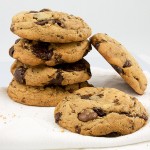 Jacques Torres's secret chocolate chip cookie recipe, Jacques Torres's recipe for chocolate chip cookies, bakery style chocolate chip cookies A photo of a stack of Jacques Torres's Secret Chocolate Chip Cookies placed on a white napkin.