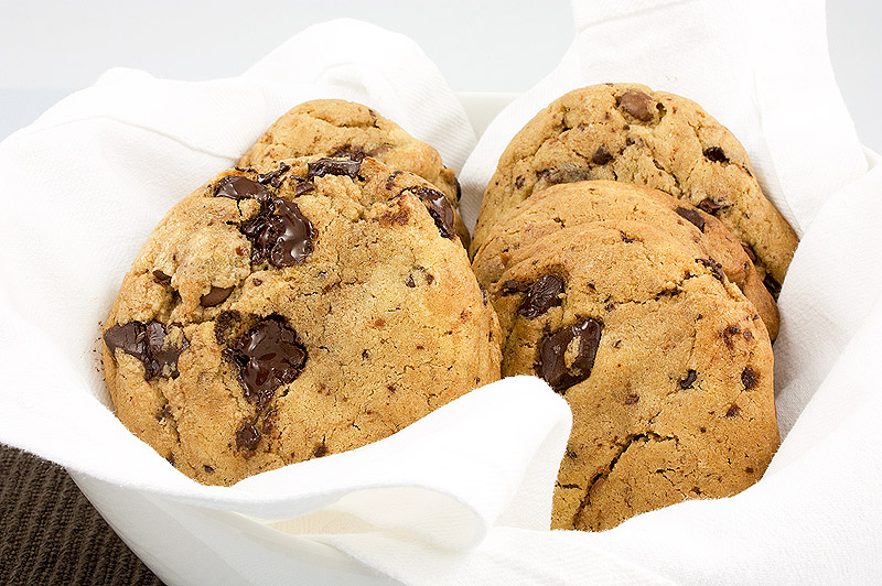 how to make the best chocolate chip cookies, secret to best chocolate chip cookies, secret to the best chocolate chip cookies A photo of a bowl lined with a white, cloth napkin containing freshly baked chocolate chip cookies.