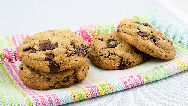 decadent chocolate chip cookies, easy chocolate chip cookie recipe, tips for making the best chocolate chip cookies A photo of chocolate chip cookies on a multi-coloured cloth napkin.