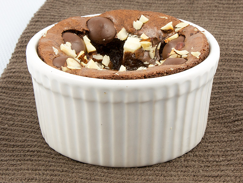 easy brownie recipes, fudgy brownies recipe, recipe for David Lebovitz's brownies A photo of Robert's Absolute Best Brownies in a white ramekin placed on a brown tea towel.