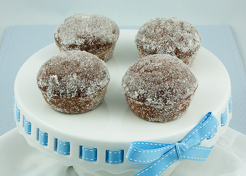 easy muffin recipes, muffin recipes, easy breakfast recipes A photo looking down on Sugared Chocolate-Spiced Muffins on a white cake stand with a pale blue ribbon.