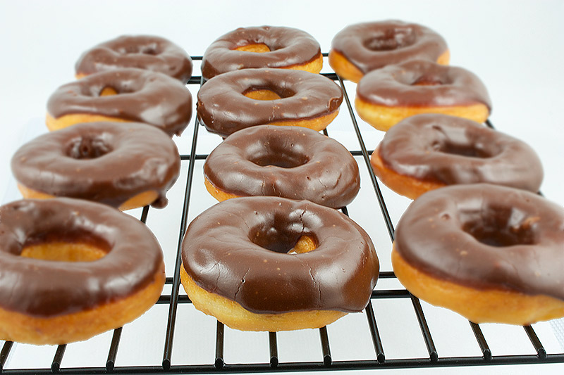 chocolate donut, chocolate glaze, making donuts, donut recipes A photo of chocolate glazed donuts cooling on a wire rack.