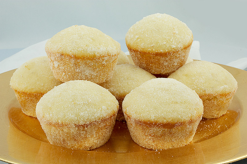 donut muffins, recipes for a crowd, easy muffin recipes A close up photo of sugar donut muffins on a gold plate.