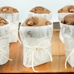 easy breakfast recipes, double chocolate muffins, easy snack recipes A photo of Nigella Lawson's double chocolate chip muffins wrapped in parchment paper and tied with string and placed on a wooden tray.