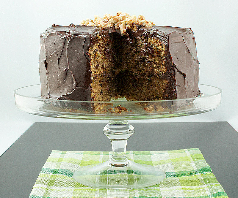 recipe for salted candied peanuts, how to make salted candied peanuts, how to make easy ganache frosting A photo of David Lebovitz's Banana Cake with Mocha Frosting and Salted Candied Peanuts with a slice removed and displayed on a glass cake stand.