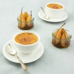 Maple Crème Brûlée with Poached Forelle Pears A photo of Maple Creme Brulee in white ovenproof dishes served with poached Forelle pears in its poaching liquid and served in glass ramekins.