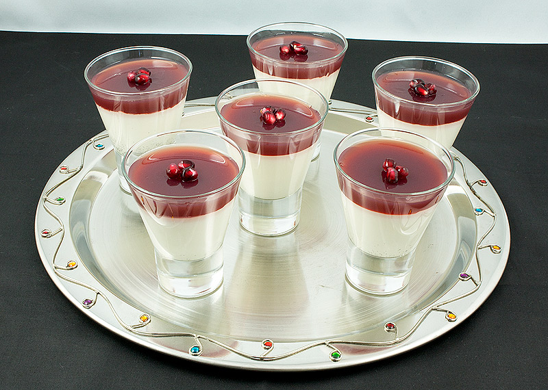 coconut panna cotta, pomegranate jelly recipe, panna cotta recipes A photo of an array of Vanilla-Coconut Panna Cotta with Pomegranate Jelly layered desserts served in small martini glasses.