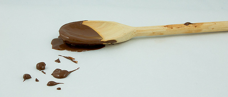 chocolate spritz cookies, spritz cookies, Christmas spritz cookies A photo of a wooden spoon covered in luscious dark chocolate.