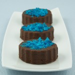 Chocolate Marshmallow Fudge A photo of 3 pieces of Chocolate Marshmallow Fudge decorated with crushed blue candy canes.