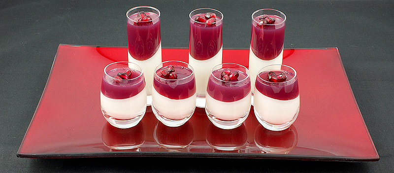 panna cotta dessert, pomegranate recipes, recipe for panna cotta A photo of an array of Vanilla-Coconut Panna Cotta with Pomegranate Jelly desserts on a red tray.