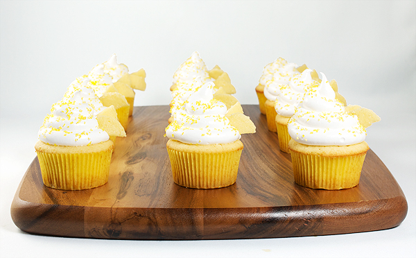 Beehive Cupcakes-Honey-Kissed Yellow Cupcakes with Meringue Icing A photo of Beehive Cupcakes-Honey-Kissed Yellow Cupcakes with Meringue Icing on a wooden board.