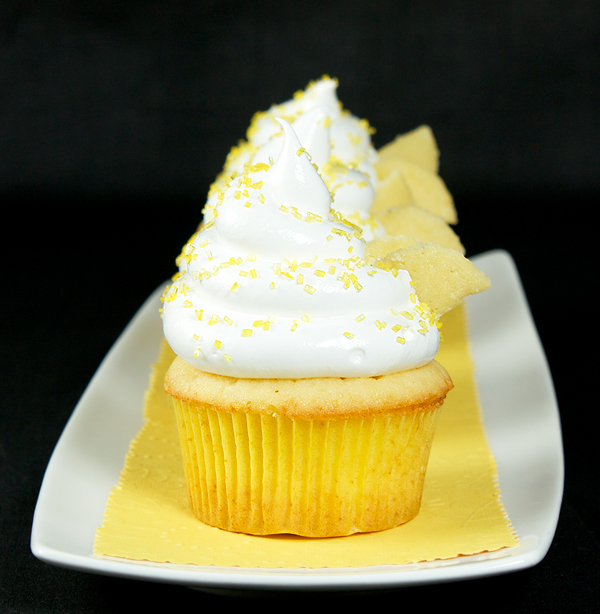 Beehive Cupcakes A photo of Beehive Cupcakes displayed in a row on a white rectangular dish.