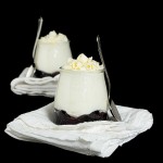 White Chocolate Mousse & Blueberry Compote Parfait A photo of White Chocolate Mousse & Blueberry Compote Parfait garnished with White Chocolate curls.