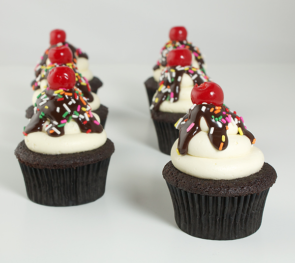 best chocolate cupcakes, vanilla frosting recipe, vanilla buttercream frosting A photo taken looking down on six Hot Fudge Sundae Cupcakes.