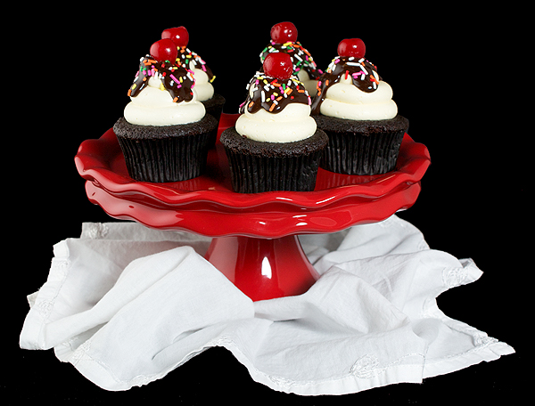 easy chocolate cupcakes, recipe for chocolate cupcakes A photo of Chocolate Cupcakes decorated to resemble Hot Fudge Sundaes with white Fluffy Vanilla Frosting, a drizzling of Chocolate Ganache, a sprinkling of colourful nonpareils and topped with a maraschino cherry