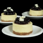 Mini Blueberry-White Chocolate Cheesecakes A photo of 3 Mini Blueberry-White Chocolate Cheesecakes desserts.