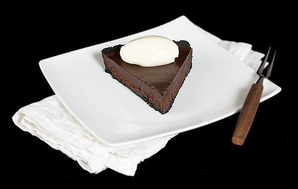 Chocolate Glaze A photo of a slice of Chocolate Tart with Chocolate Glaze and topped with a quenelle of Mascarpone Cream.