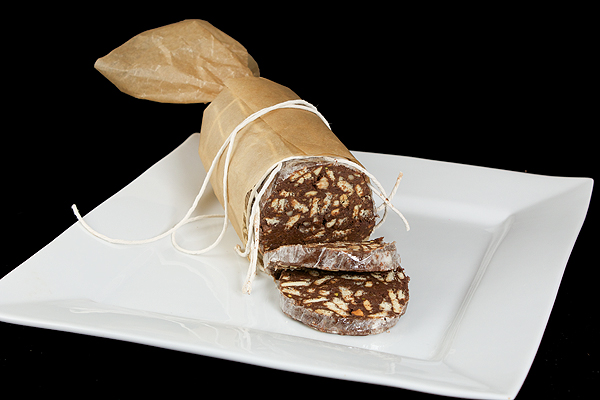 Italian desserts recipes, chocolate treats, Italian Desserts Recipes A photo of a Chocolate Salami wrapped in parchment and string displayed on a large, white square dish.