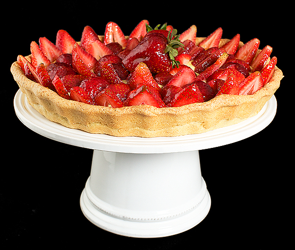 Fruit Tart A photo of an Italian Fruit Tart filled with Crema Pasticcera and topped with fresh strawberries coated with a Grand Marnier-Apricot Glaze.