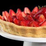 Crostata di Fragole con Crema Pasticcera e Chantilly {Strawberry Tart} A photo of an Italian Dessert, Crostata di Fragole con Crema Pasticcera e Chantilly {Strawberry Tart} displayed on a white cake stand.