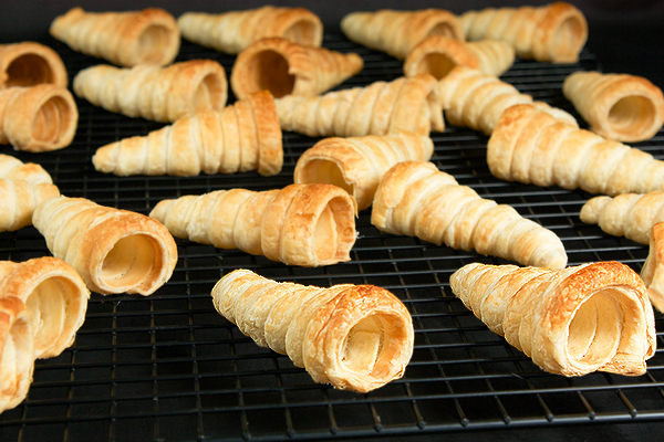 Puff Pastry Horns A photo of Puff Pastry Horns cooling on a wire rack.