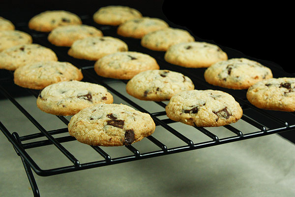 Grace's Sweet Life Cookies A cropped photo of Italian Cookies, hazelnut and chocolate chunk cookies, cooling on a black wire rack.