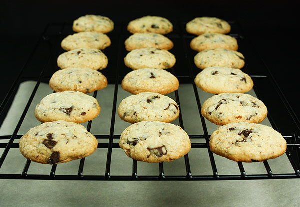 Grace's Sweet Life Italian Cookie-Hazelnut Cookies with Chocolate Chunks A photo of Italian Hazelnut Cookies cooling on a black wire rack.