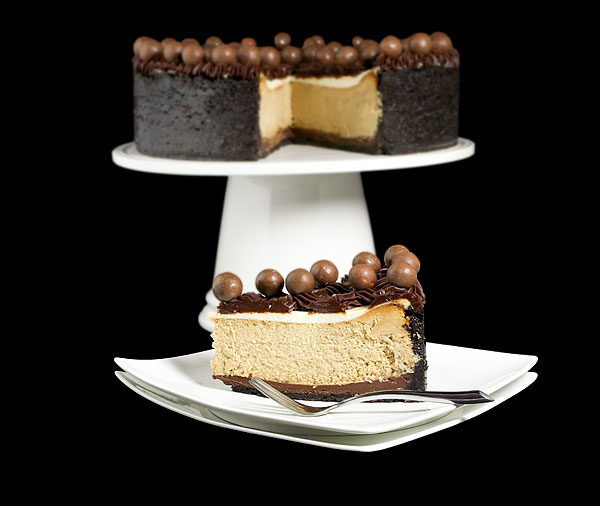 Grace's Sweet Life Easy Cheesecake A photo of an Easy Cheesecake, Cappuccino Fudge Cheesecake with a slice removed on a white cake stand and a slice of cheesecake on a white dessert dish set in front.