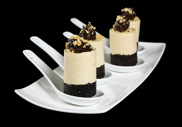 Grace's Sweet Life Mini Oreo Cheesecakes A photo of 4 Mini Oreo Cheesecakes with Fudge Sauce and chopped peanuts displayed on Chinese spoons.