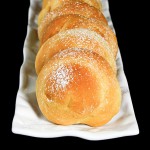 Grace's Sweet Life Pastry Buns A cropped photo of Italian Pastry Buns arranged in a row on a white, rectangle-shaped dish.