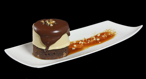 Grace's Sweet Life Triple-Chocolate Fudge Brownies A photo of an Italian dessert, semifreddo sitting on a Triple-Chocolate Fudge Brownie with a spoonful of chocolate sauce.