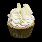 Grace's Sweet Life White Chocolate Raspberry Cupcakes A photo of a White Chocolate Raspberry Cupcake frosted with Swiss Meringue Buttercream and decorated with chocolate curls and gold dust.