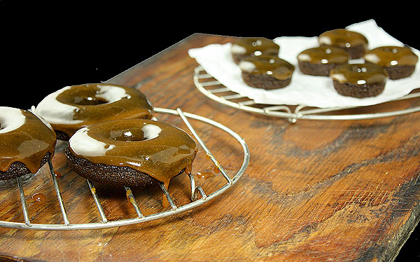 Cake Doughnuts from Grace's Sweet Life A photo of cake doughnuts dipped in salted caramel cooling on wire racks.