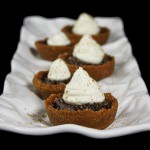 Grace's Sweet Life Chocolate Cream Tartlets A photo of various Chocolate Tartlets on a rectangular-shaped white textured dish.