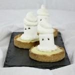 Grace's Sweet Life Ghost Tarts A photo of three Ghost Tarts on rectangular-shaped slate board.