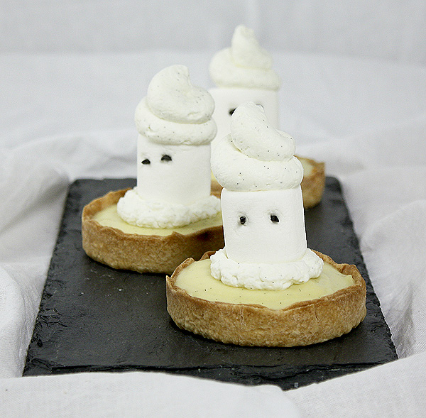 Grace's Sweet Life Ghost Tarts A photo of three Ghost Tarts on rectangular-shaped slate board.