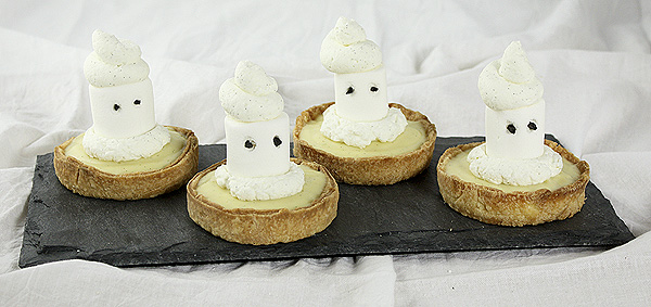 Grace's Sweet Life Marshmallow Ghost Tarts Four Marshmallow Ghost Tarts displayed side by side on a rectangle-shaped dark slate board.