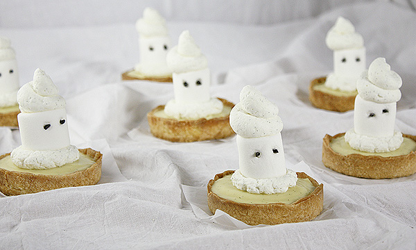 Marshmallow Ghost Tarts from Grace's Sweet Life Marshmallow Ghost Tarts randomly displayed on a bunched up linen white sheet.
