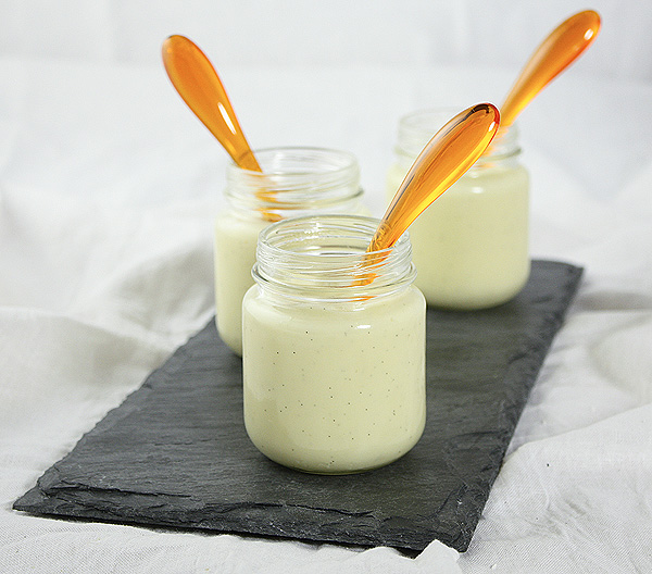 Vanilla Bean Pudding from Grace's Sweet Life A photo of three Vanilla Bean Pudding desserts in glass jars displayed with orange dessert spoons.