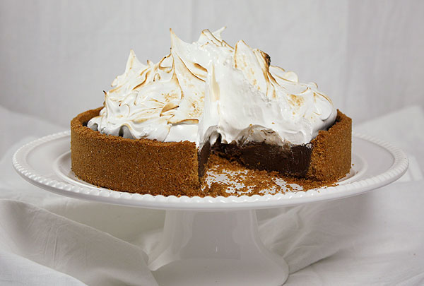 A photo taken of Baileys S mores Pie with slice removed exposing interior.
